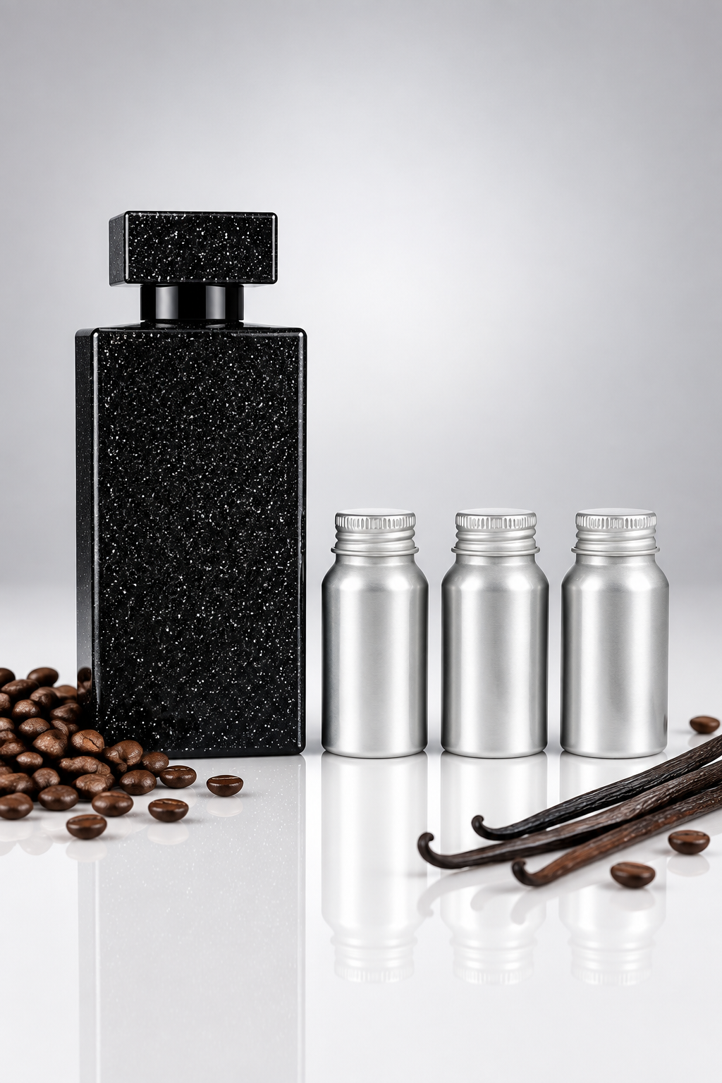 Black perfume bottle with three small 500 ml perfume oil canisters in a row as a wholesale pack shot